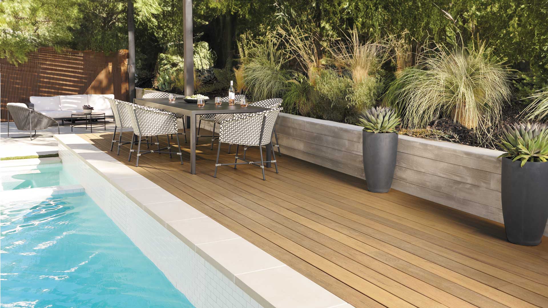 A poolside deck built with Tigerwood deck boards from the TimberTech Composite Legacy Collection