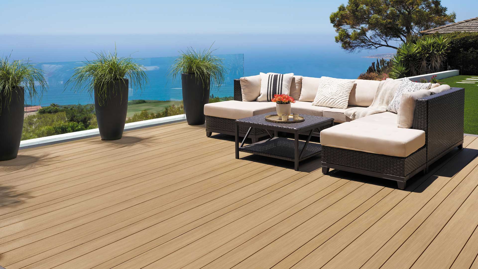 Light brown deck atop a grassy hill looking out upon the coast of California