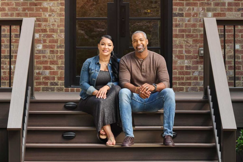 Egypt Sherrod and Mike Jackson pose for a photo on the steps of their new TimberTech porch