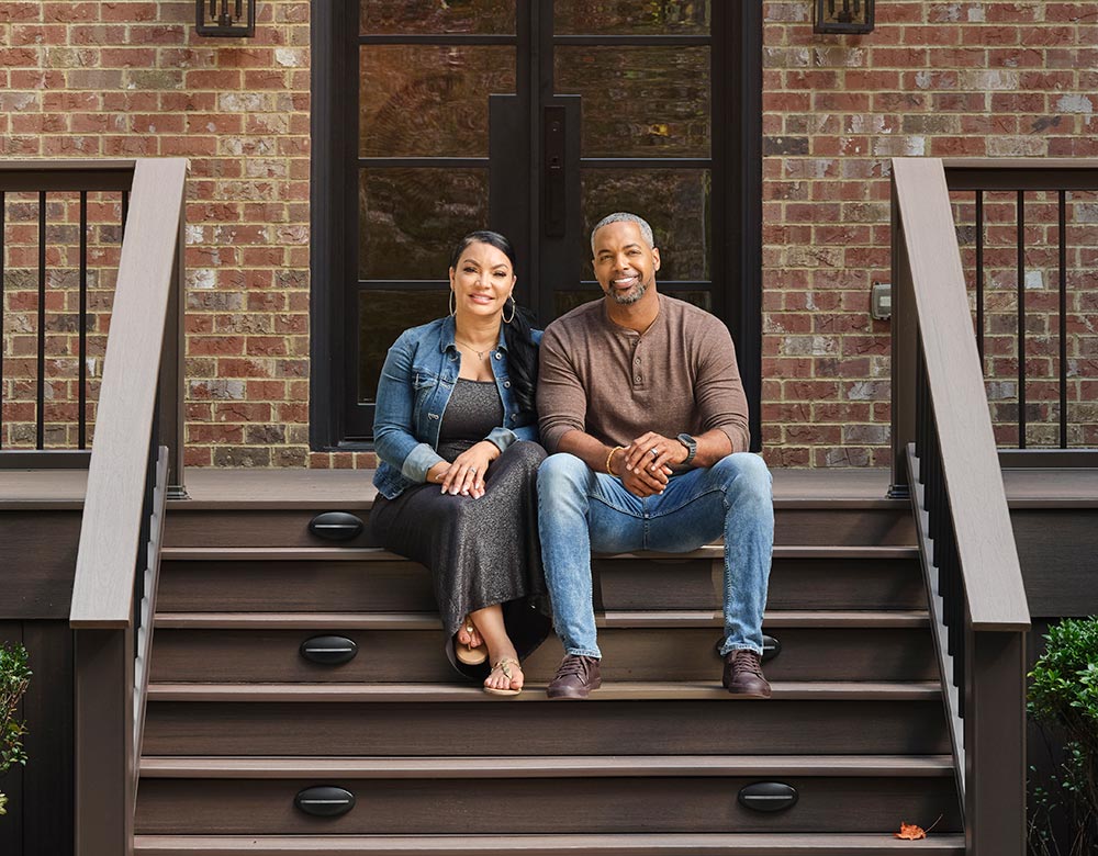 Egypt Sherrod and Mike Jackson pose with big smiles on the steps of their new outdoor space