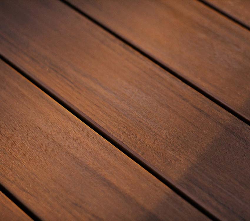 Close up shot of the color variation and detail seen in TimberTech Advanced PVC Mahogany deck boards