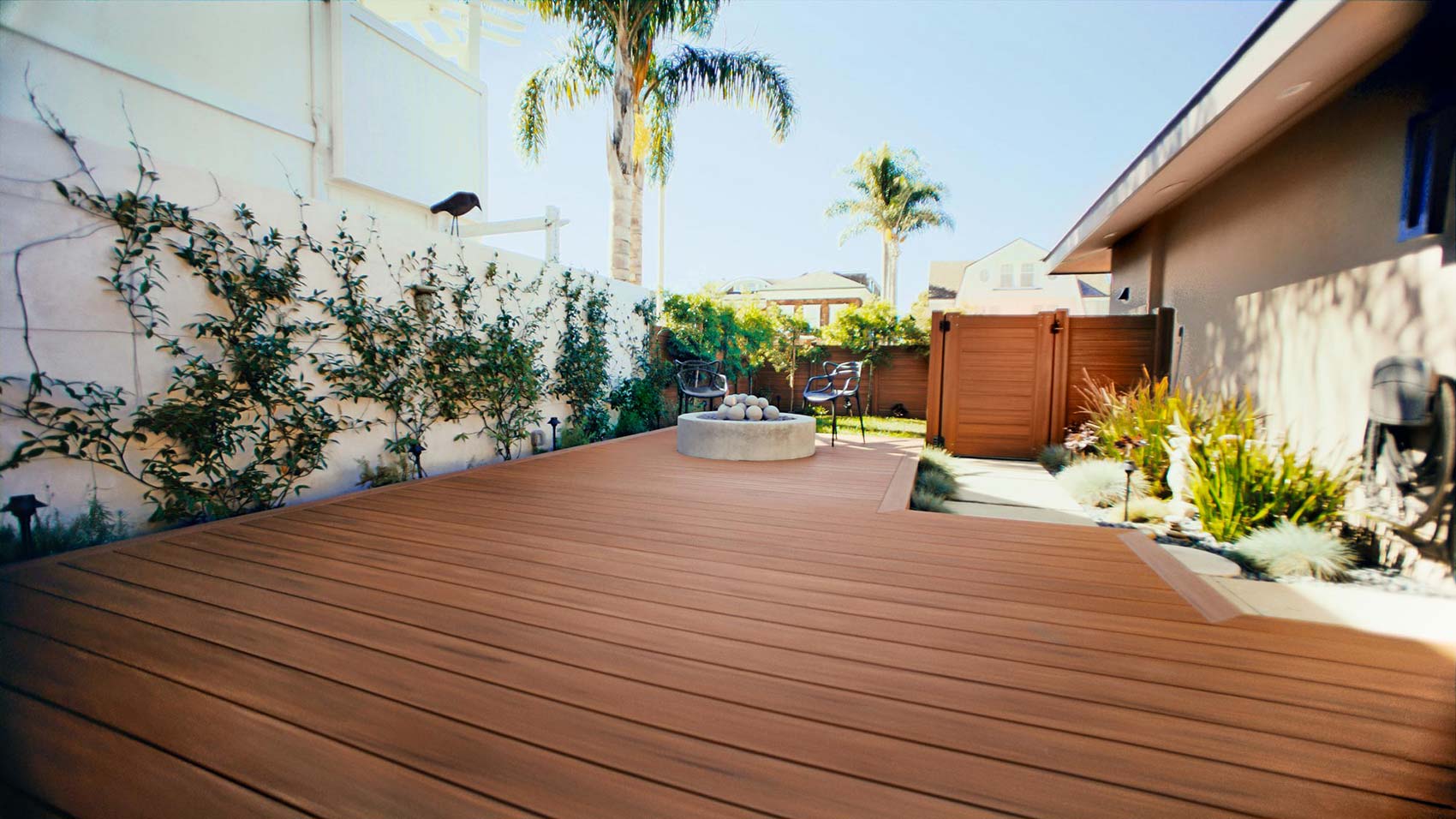 Wide angle shot of private fenced in portion of her deck in the yard