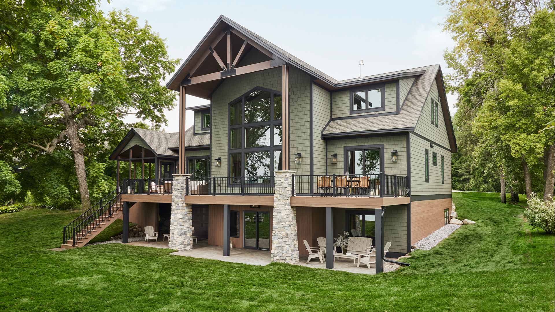 Distant shot of a large family home with a deck that spans the front