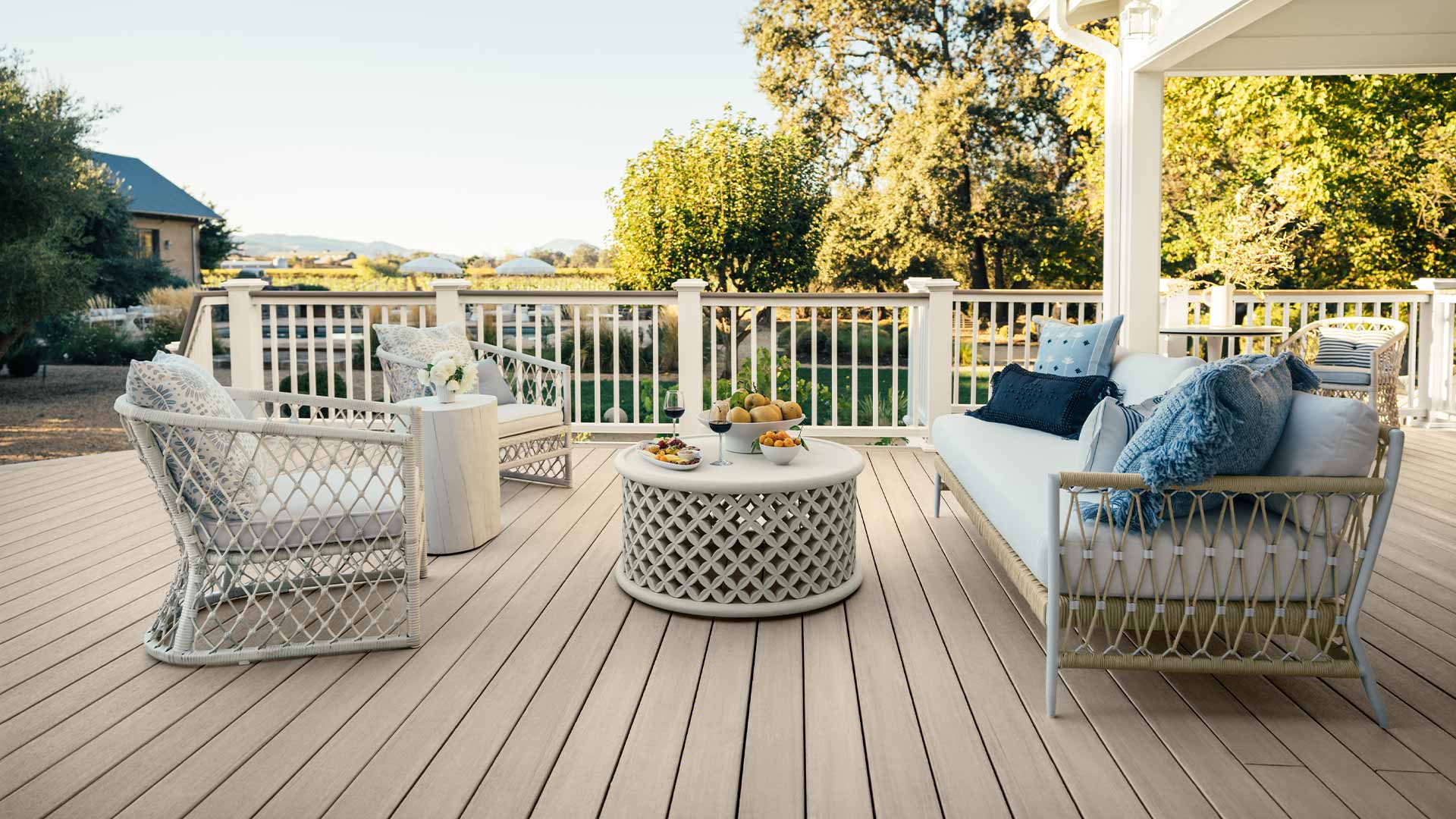 Vineyard outdoor space on light tan deck with outdoor furniture and charcuterie