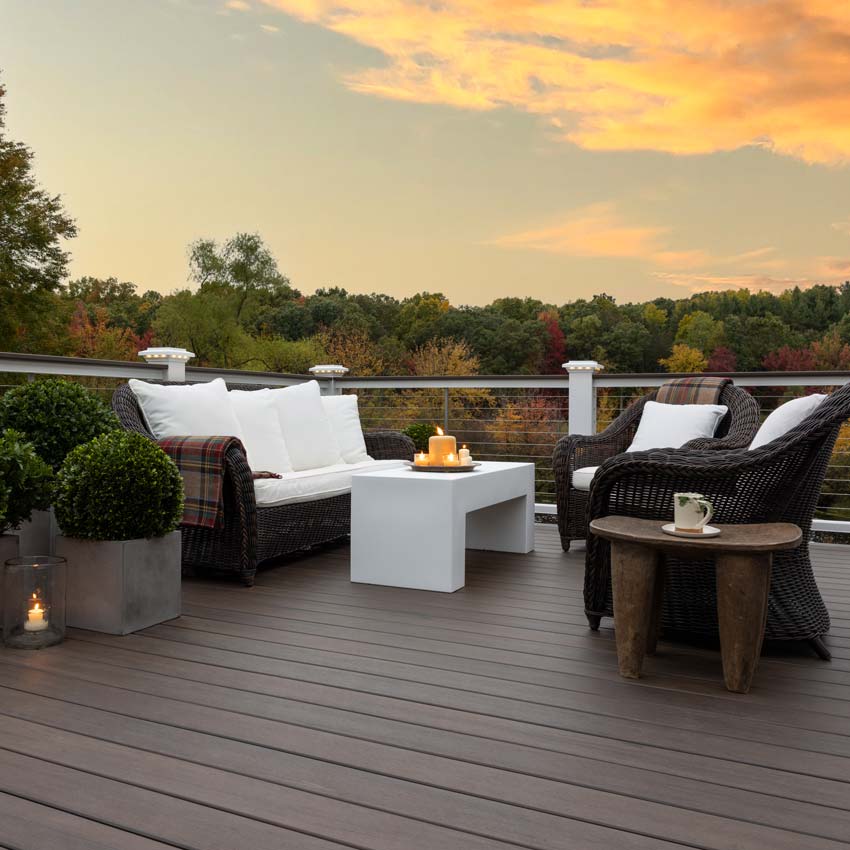 New decking with a sunset backdrop, the decking is TimberTech's Legacy Collection in Mocha