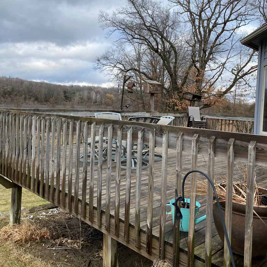 Old, rotten railing on a wooden deck