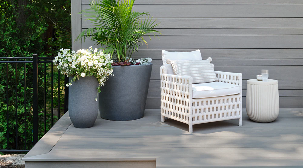 Composite deck with striking deck board pattern and patio furniture