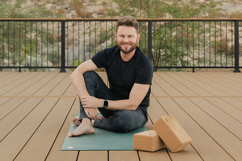 Bobby Berk sits on his TimberTech deck built with tan deck boards