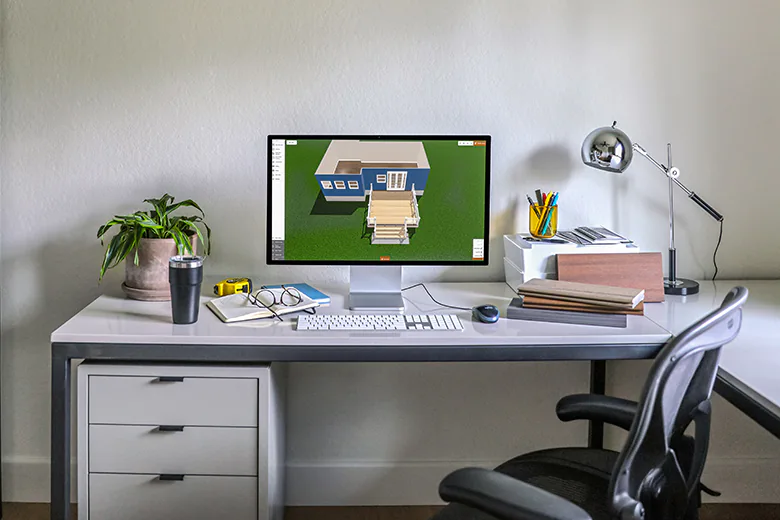 A home office with a desktop computer that has TimberTech's 3D Deck Designer displayed on the monitor