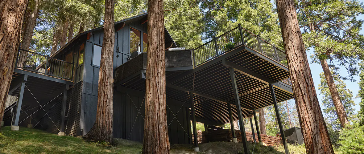 View from the underside of a deck built with an aluminum substructure on a hill in the woods.
