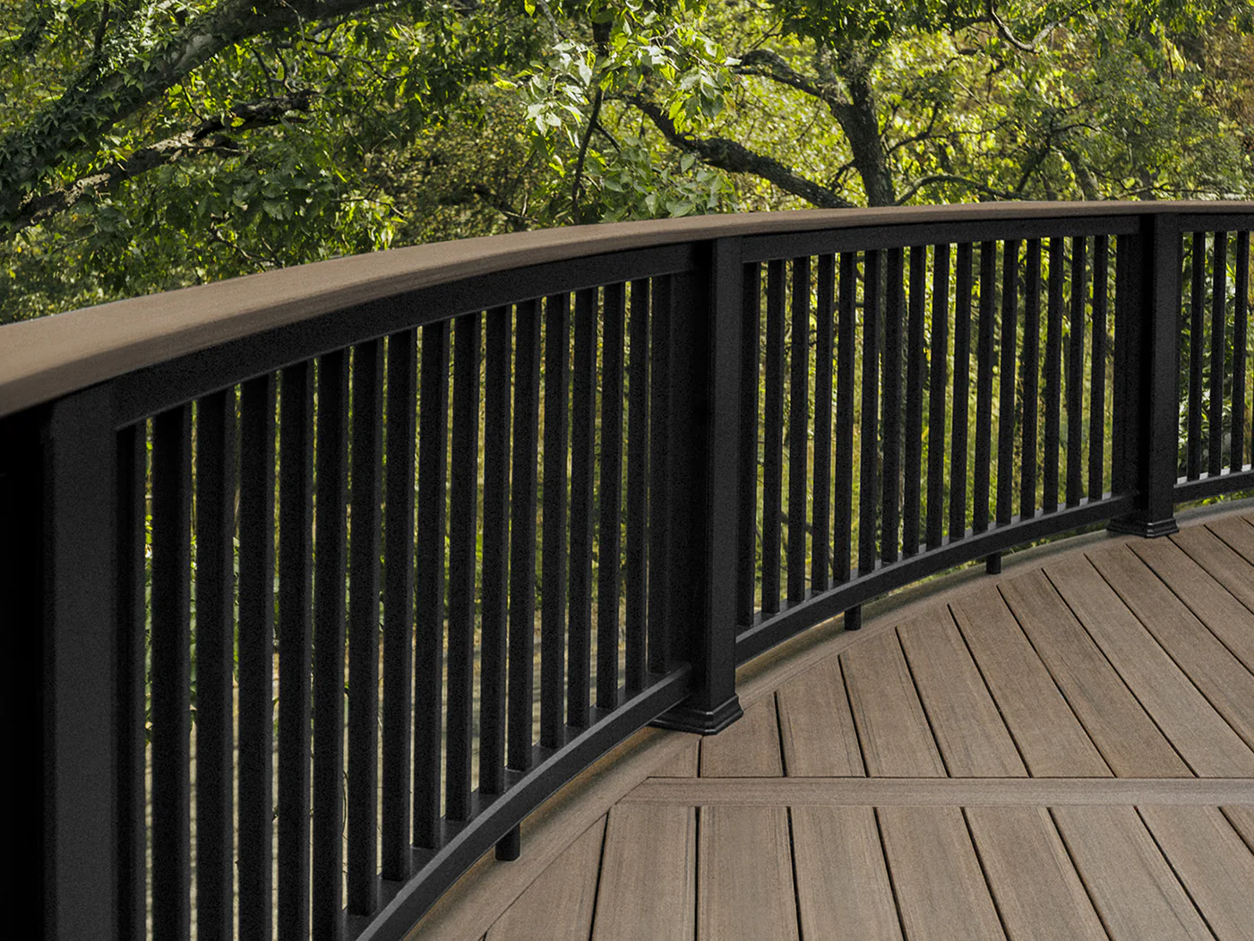 Curved composite black railing with vertical baluster infill. A deck board is used as the top rail.